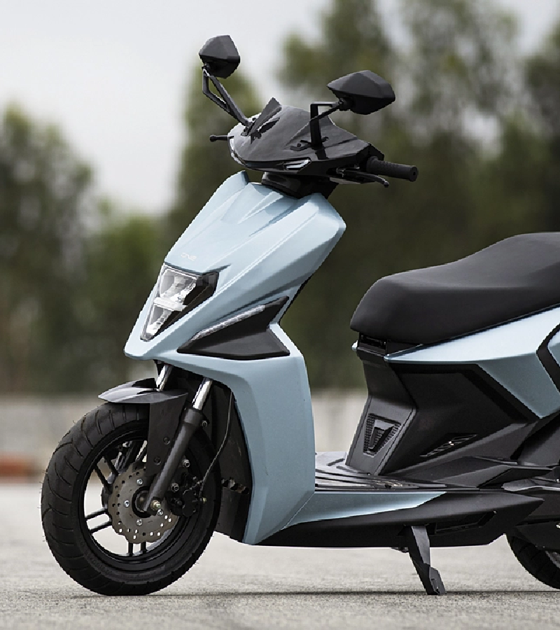 Young man driving electric scooter.